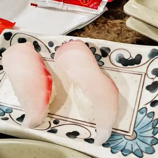 two pieces of sushi on a plate