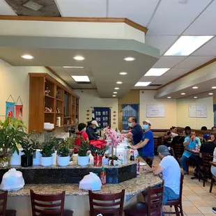 eople sitting at tables in a restaurant