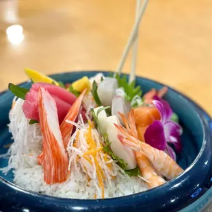 a bowl of rice with shrimp and vegetables