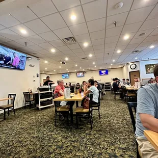 people sitting at tables in a restaurant