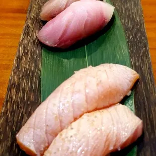 a variety of sushi on a wooden platter