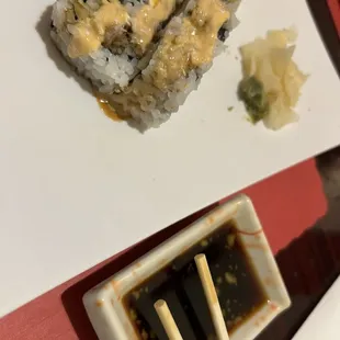 a plate of sushi and chopsticks