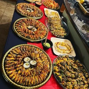 a table full of different types of sushi