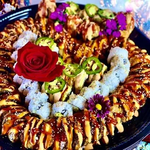 a plate of sushi with a rose