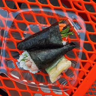 two pieces of sushi on a plastic plate