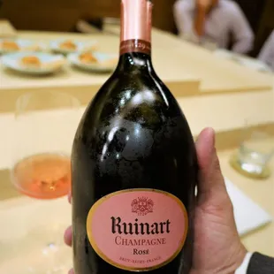 a person holding a bottle of wine