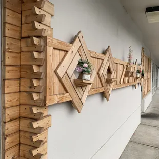 a row of wooden stars on the side of a building