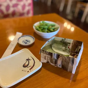 Edamame complete with an origami bowl made from paper for trash shells.