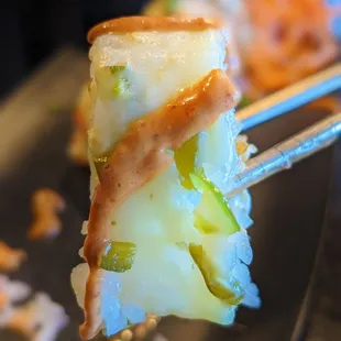 a piece of sushi on a fork