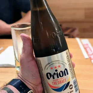 a person holding a beer bottle