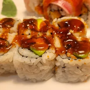 a variety of sushi rolls on a plate