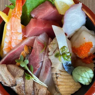 a close up of a bowl of sushi