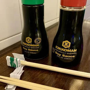 two bottles of sushi and chopsticks