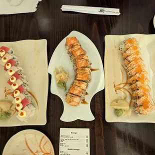 three plates of sushi on a table