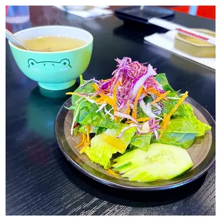 a plate of salad and a bowl of soup