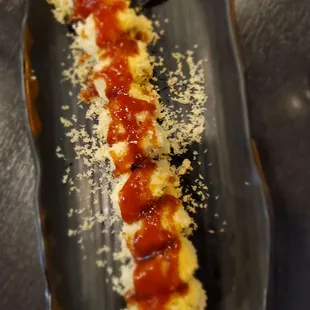 a sushi on a black plate