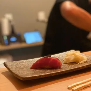 a sushi dish with chopsticks