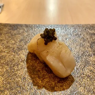 Scallop topped with caviar