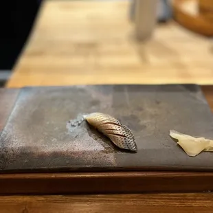 a sushi on a cutting board
