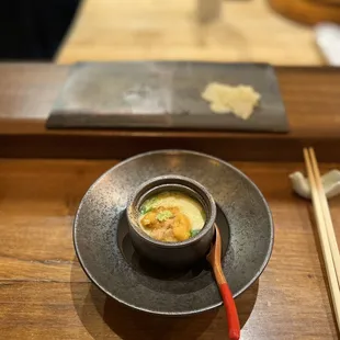 a bowl of soup and chopsticks