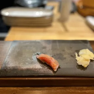 a sushi on a slate plate
