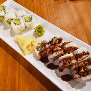 a plate of sushi rolls on a wooden table