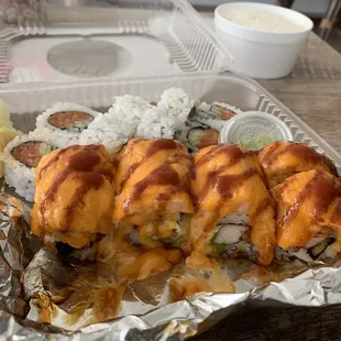 Baked salmon roll in front, spicy tuna roll in back