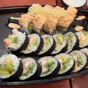 a platter of sushi with chopsticks