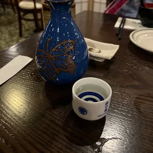 a blue vase on a wooden table