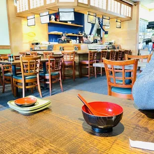 a wooden table with bowls and plates on it