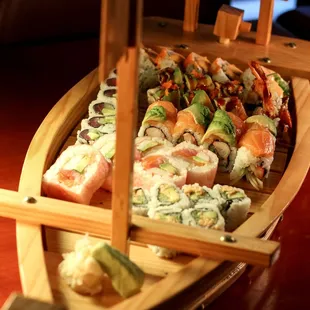 a wooden boat filled with sushi