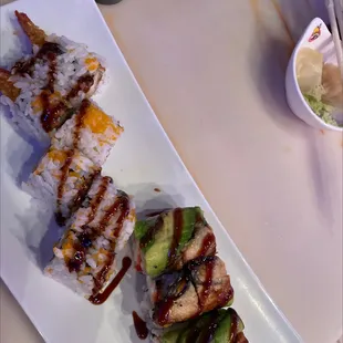 a plate of sushi and avocado