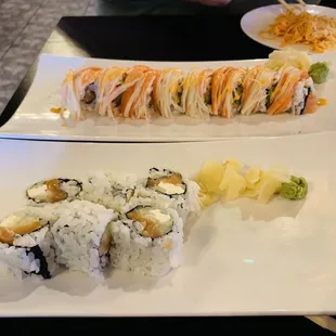 Front is Philadelphia roll and behind that is a Mt Fuji roll. Crab salad on the plate top right