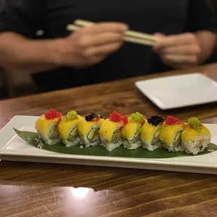 a man eating sushi at a restaurant