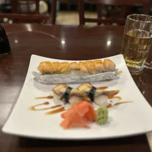 a plate of sushi and a glass of beer