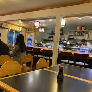 a group of people sitting at a table in a restaurant