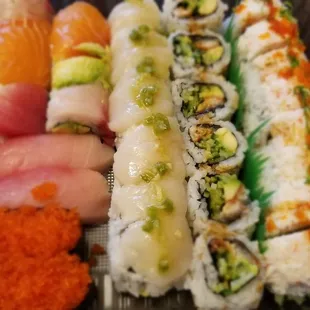 a variety of sushi in a plastic container