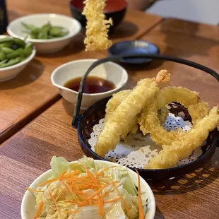 a bowl of deep fried food and a bowl of salad