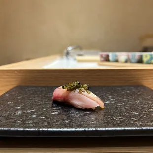 a sushi on a black plate