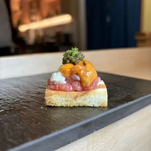 a sushi dish on a slate plate