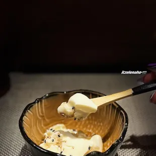 a person dipping a bowl of ice cream