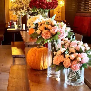 a table with flowers and a pumpkin