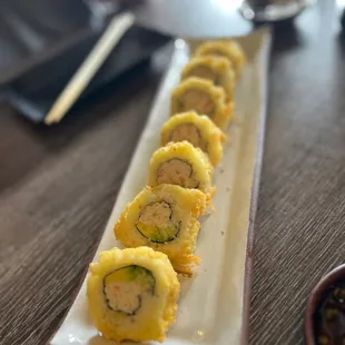 a long rectangular plate of sushi
