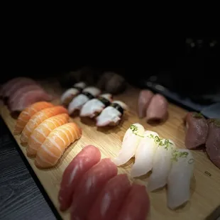 a variety of sushi on a cutting board