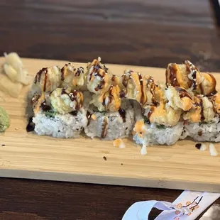 a piece of sushi on a cutting board