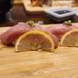 three pieces of tuna on a cutting board