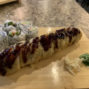 a plate of sushi and a roll