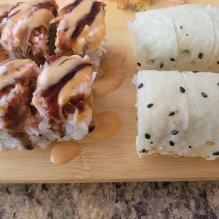 a variety of sushi rolls on a cutting board