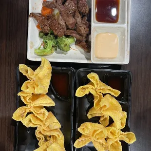 a plate of dumplings, beef and broccoli