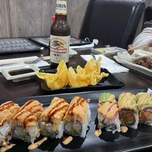 a plate of sushi and a bottle of beer